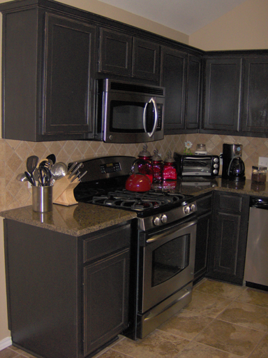 .Kitchen Cabinets painted a satin black then distressed and antiqued. 