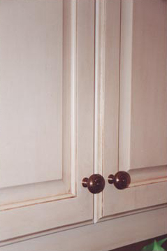 Faux painted antiqued cabinet doors close up