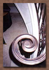 Faux painting bronze metal patina closeup of wrought iron handrail