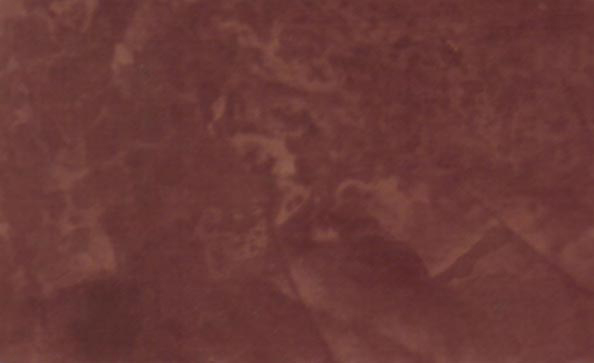 Close-up of a Venetian Plaster faux finish in a Behr color called Bacchus Red.